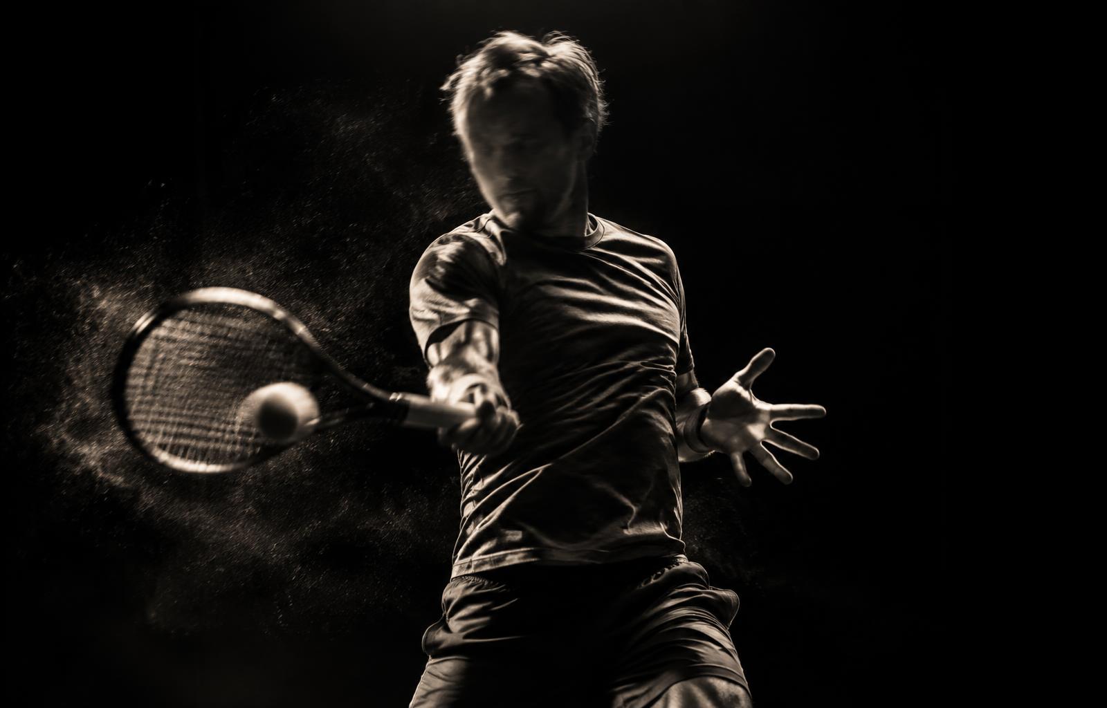 Tennis player striking a forehand